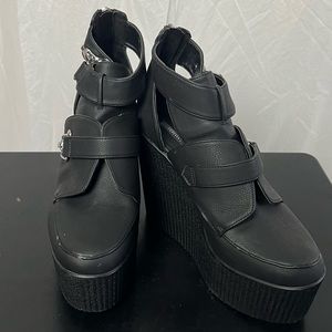 Black punk style shoes with silver metal details and silver zipper in the back